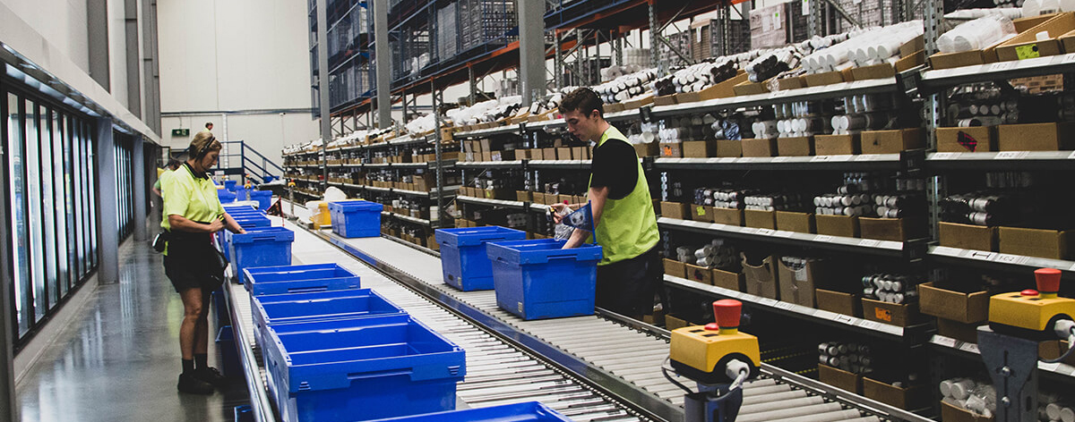 People working at distribution warehouse